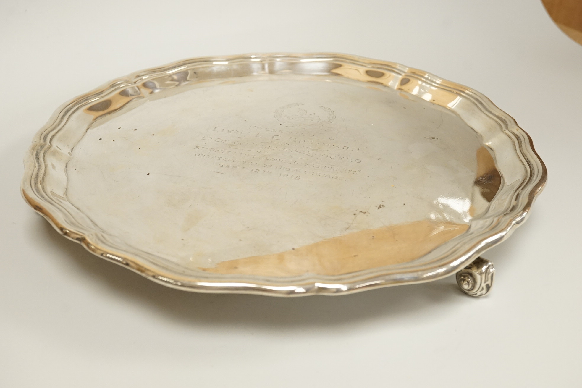 A George V silver salver, by Albert Faulkner, Sheffield, 1917, with engraved military related inscription, on three scroll feet, 25.9cm, 20.6oz.